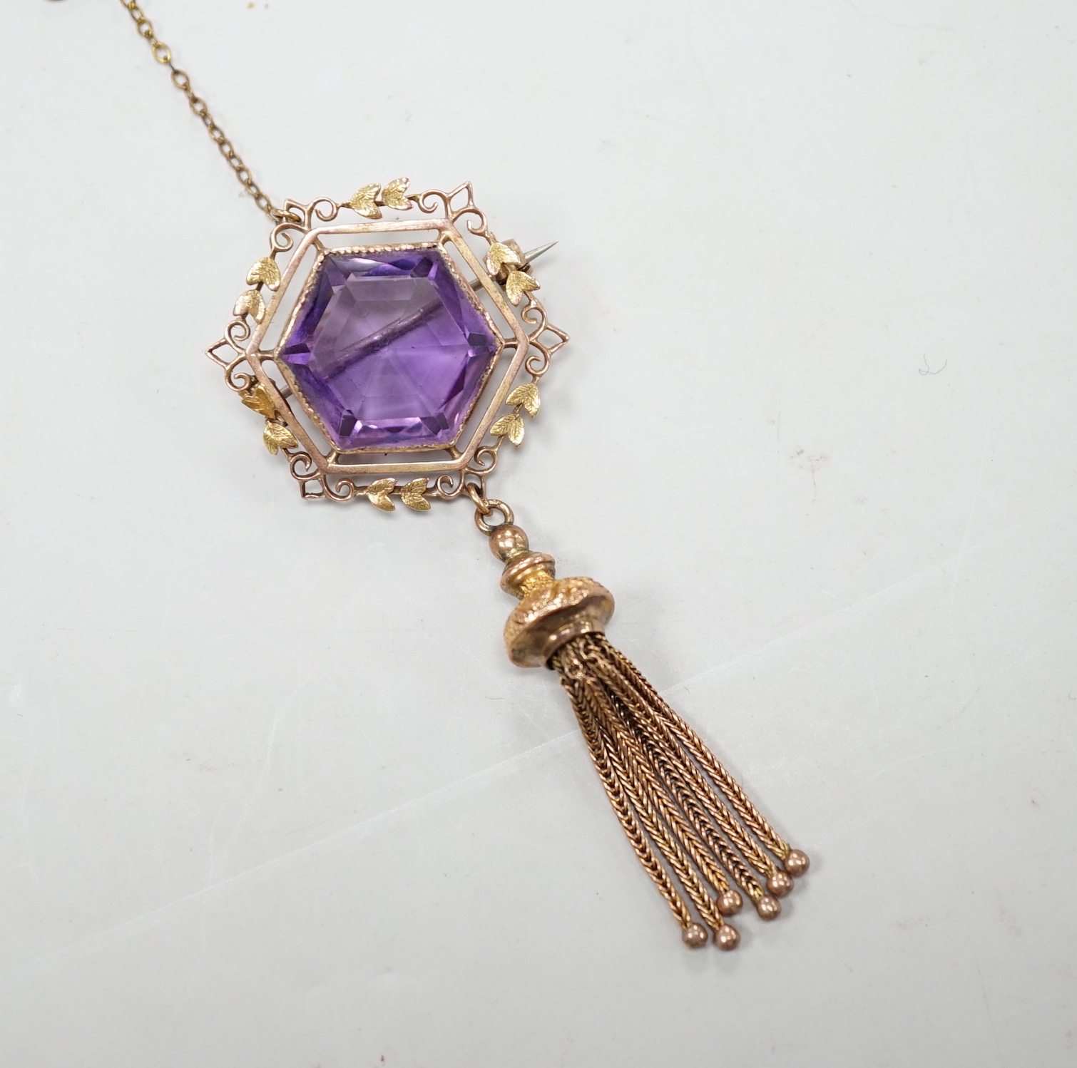An Edwardian 9ct and hexagonal cut amethyst set tassel drop brooch, overall 75mm, gross weight 10.7 grams.